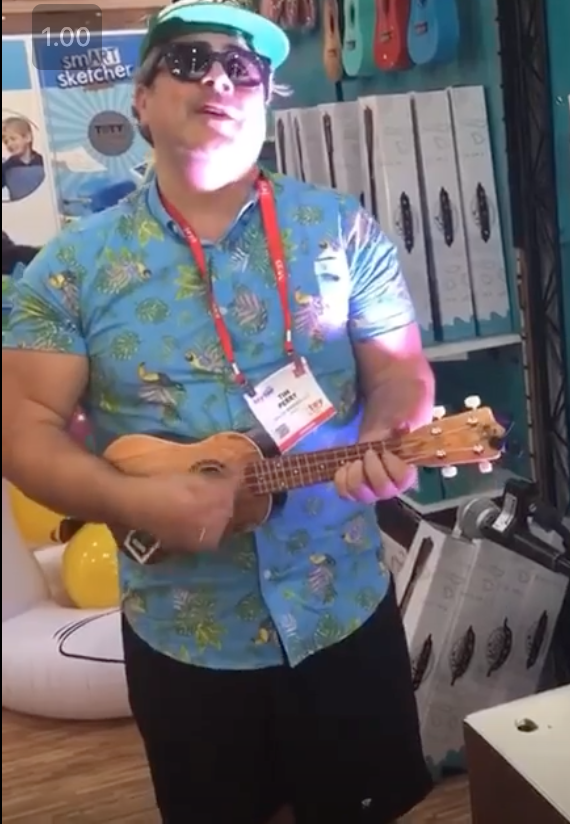 man playing guitar on trade show